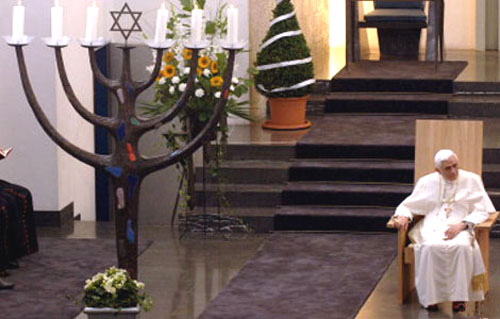 Benedict XVI sitting under a menorah